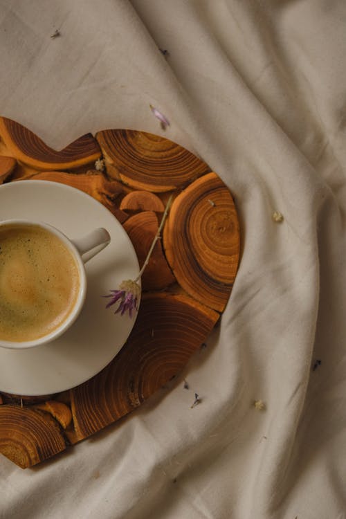 A Cup of Coffee on a Heart Shaped Wooden Board