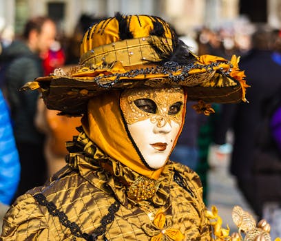 A close-up of a masked participant in a stunning gold costume at the Venice Carnival.