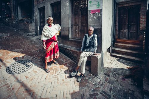 Free An elderly couple enjoying the street in a cozy urban setting on a sunny day. Stock Photo