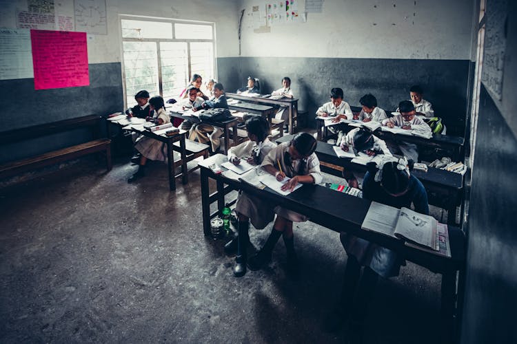 Schoolgirls And Schoolboys In Classroom