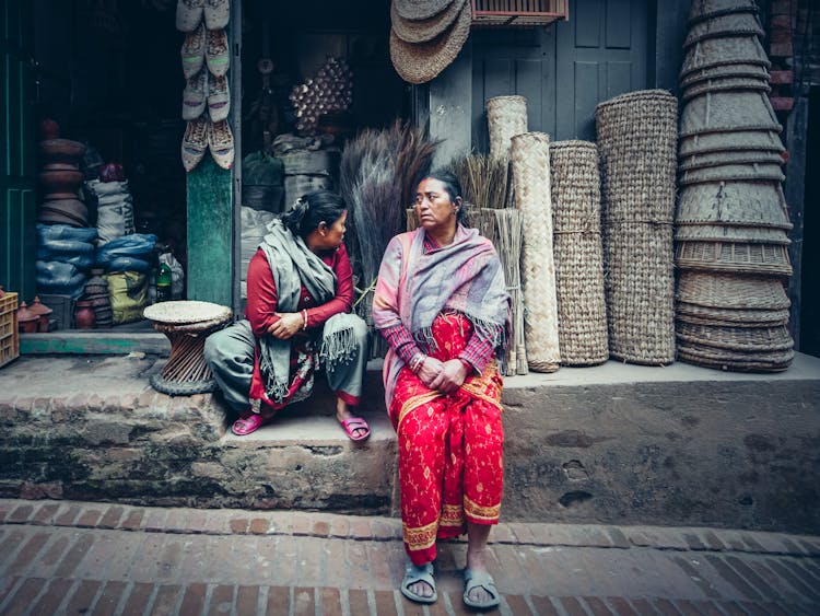 Women In Traditional Clothes Selling On Street