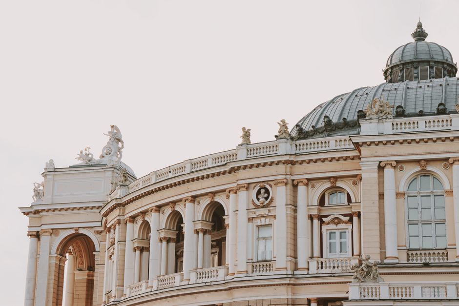 Elegant architecture featuring a dome and arches, with intricate sculptures and statues.