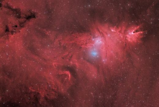 Explore the vivid colors of a red nebula against a star-filled cosmos.