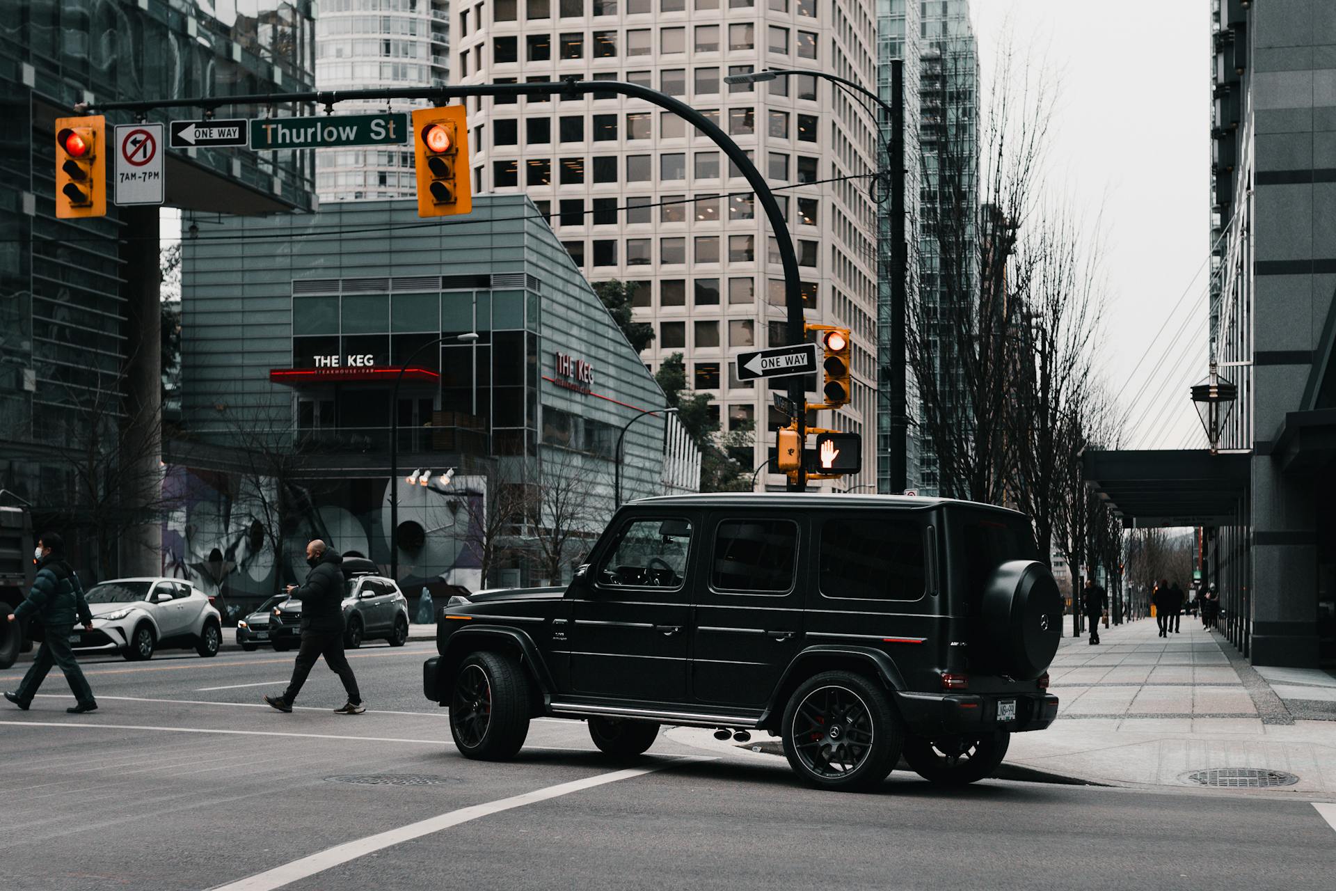 Busy intersection in downtown Vancouver featuring modern architecture and pedestrians.