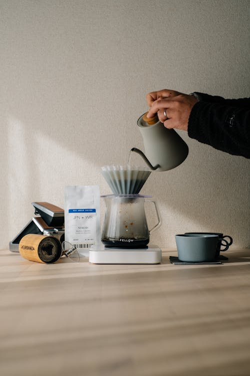 A Person Brewing Coffee with a Coffee Maker