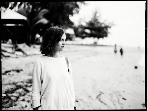 A Grayscale Photo of Woman in White Sweater