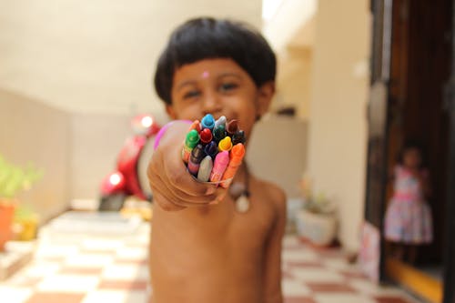 Boy Holding Crayons