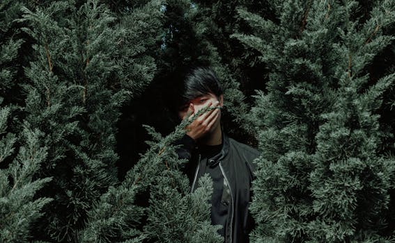 Man Wearing Black Jacket Between Tree
