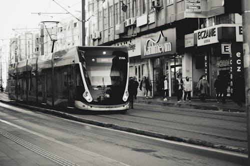 Grayscale Photo of Tram on the Road
