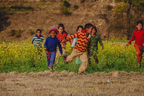 A Group of Kids Running at the Field