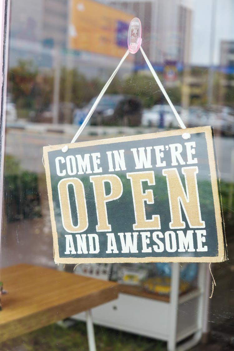 
Open Signage Hanging On The Glass