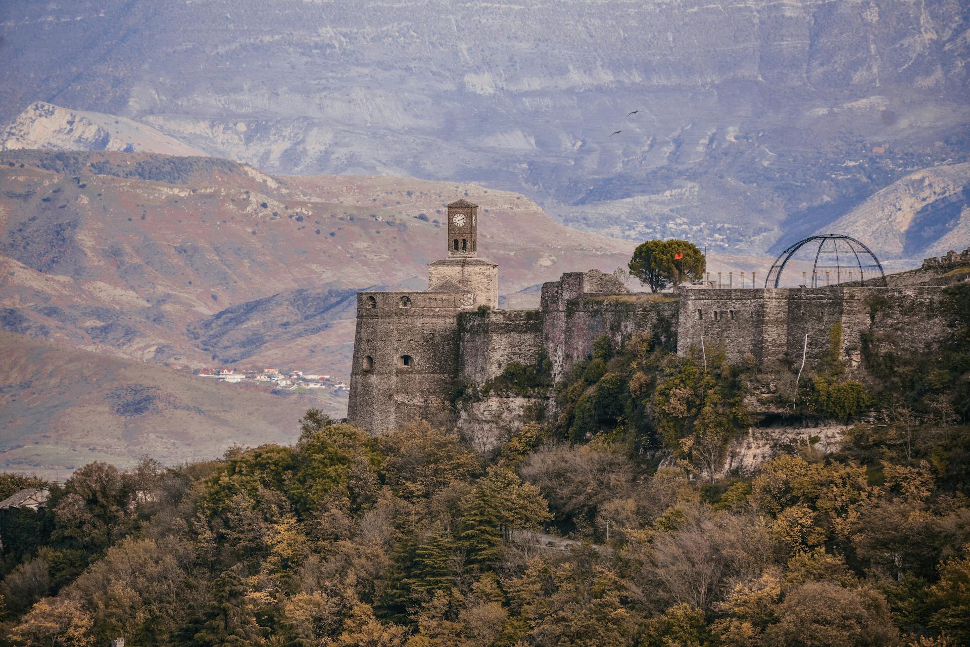 Gjirokaster Fortress stands majestically amidst the Albanian mountains, showcasing rich history and stunning architecture.