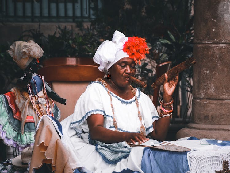 An Elderly Woman Smoking Tobacco