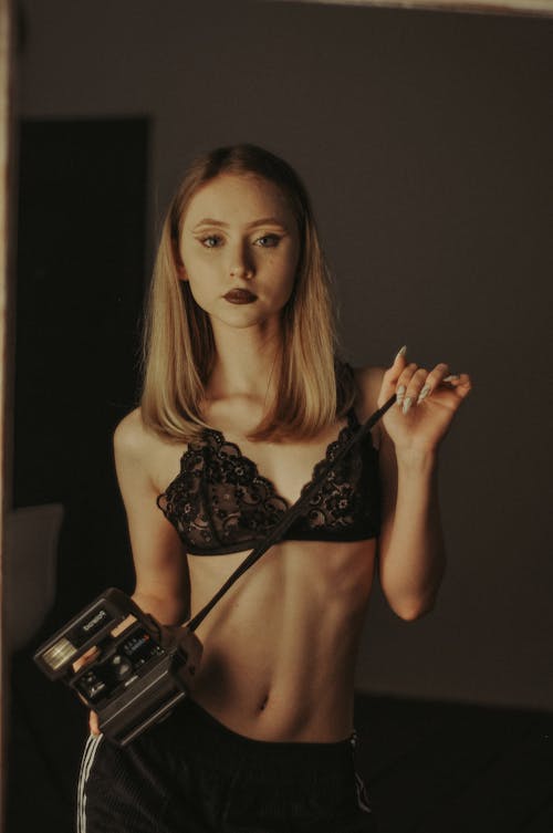 Sexy Woman in Lingerie Holding Camera