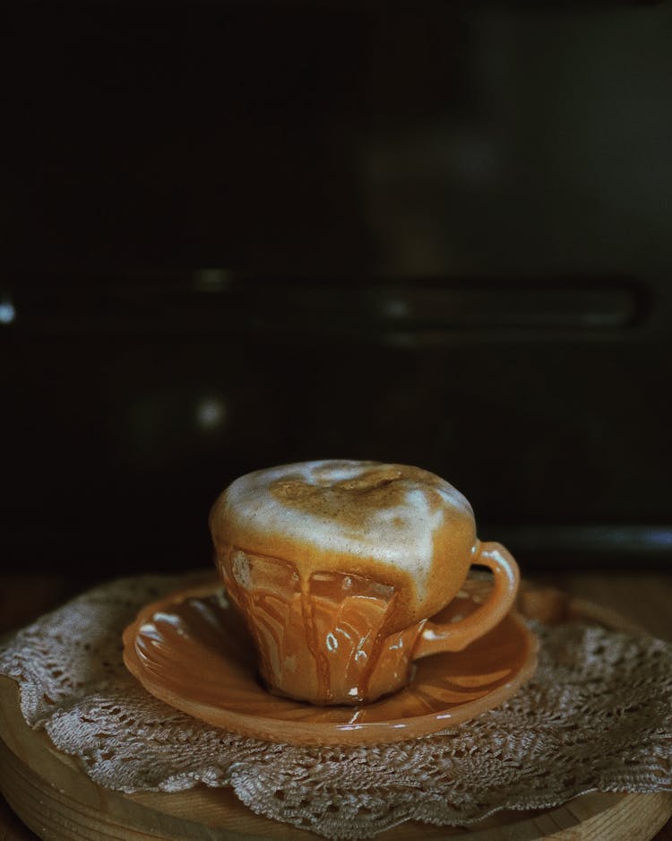 A Ceramic Cup With Overflowing Coffee