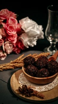 Delicate arrangement of chocolates and roses, perfect for romantic themes.
