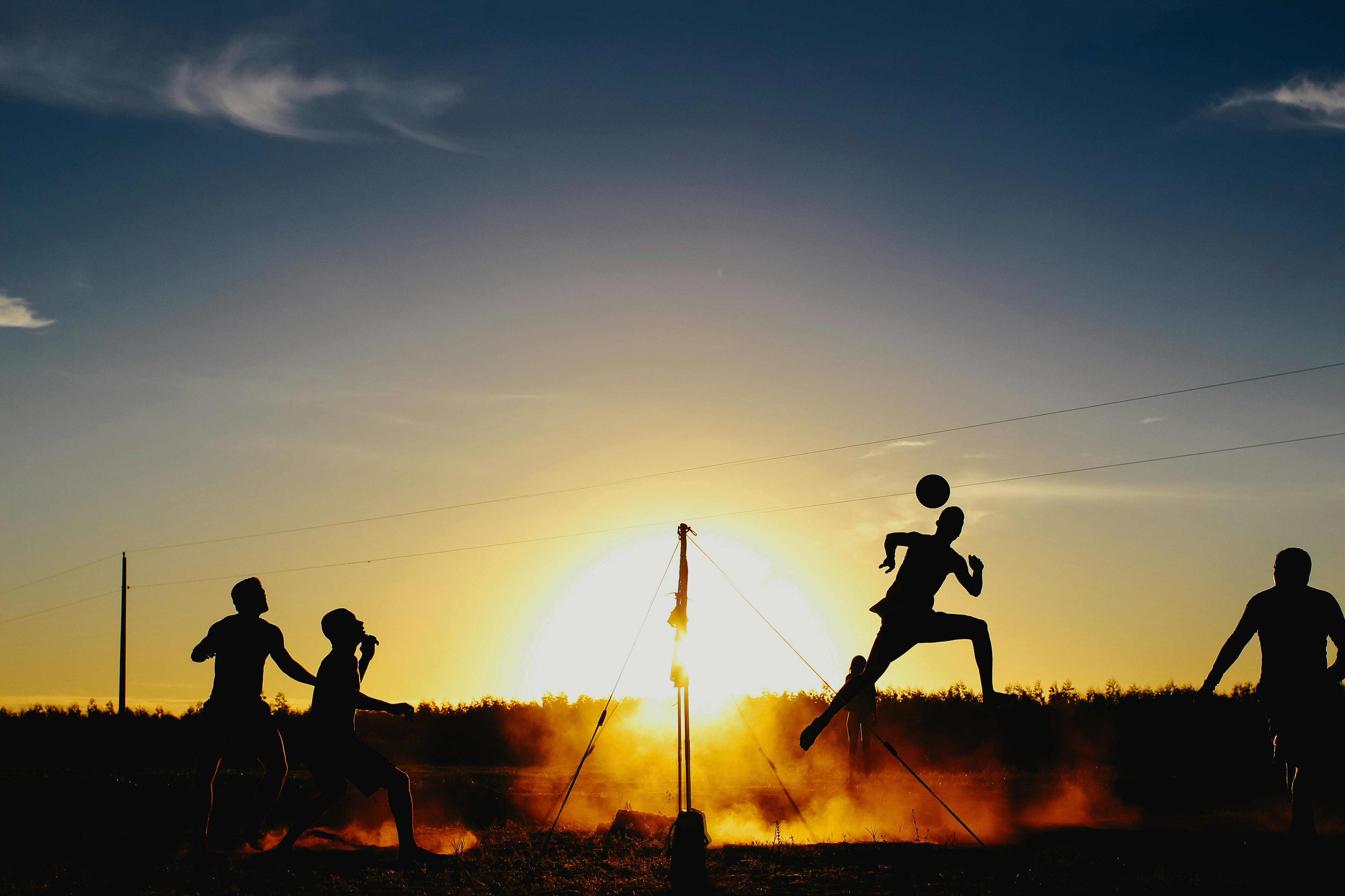 silhouettes of beach volleyball players