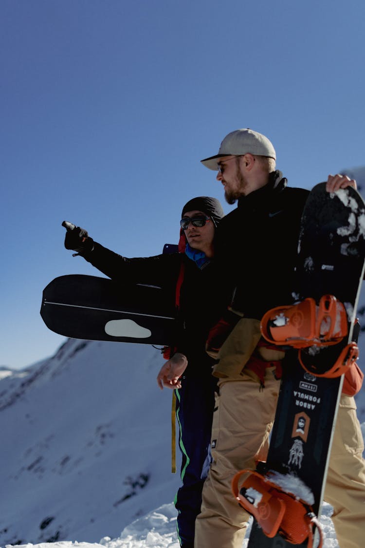 Men With Snowboards In Winter Mountains