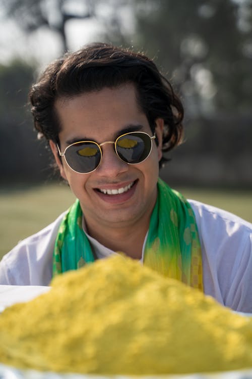 A Man in White Shirt Smiling while Wearing Sunglasses