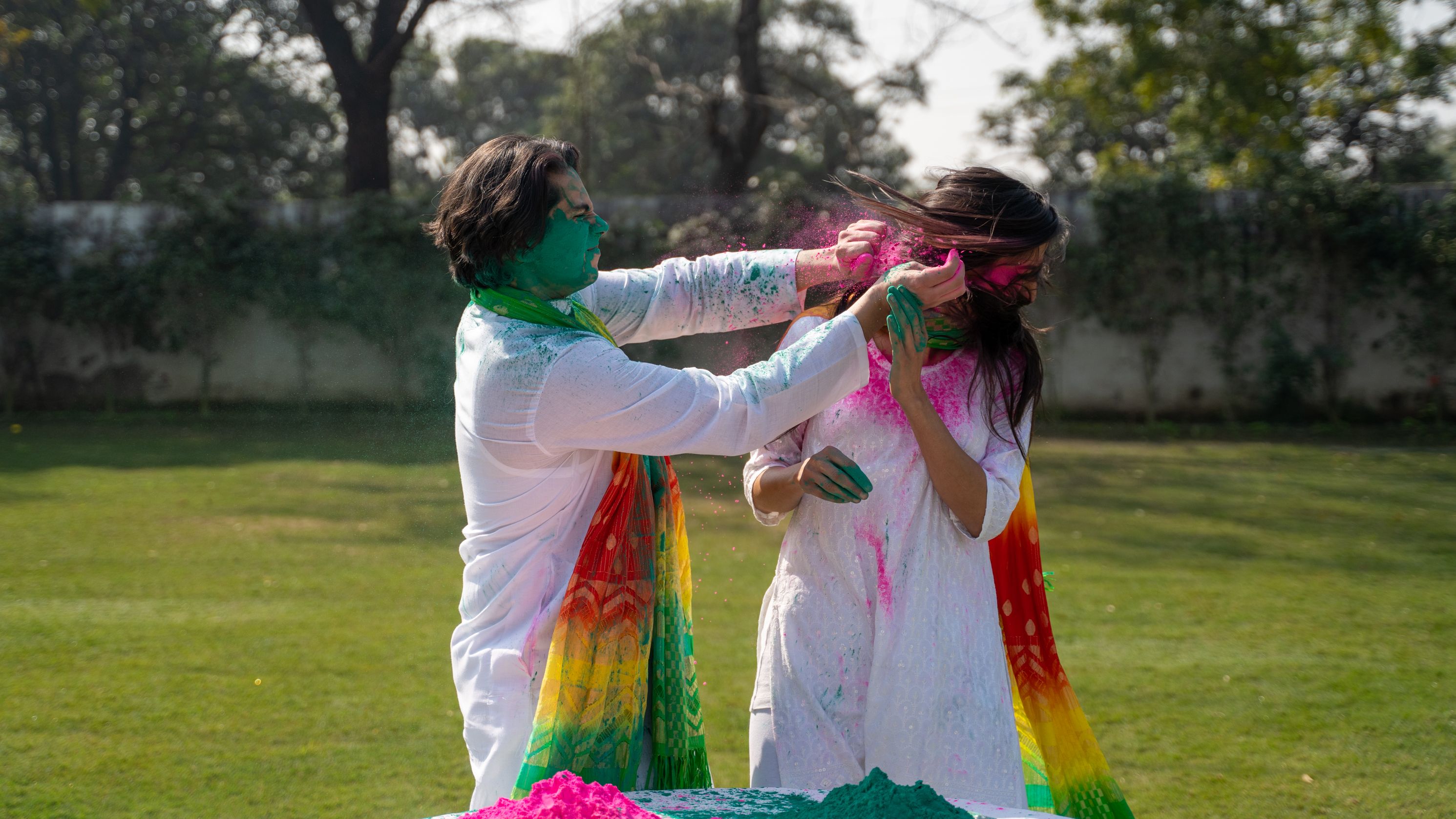 A Couple Putting Colorful Powder on Each Others Face · Free Stock Photo
