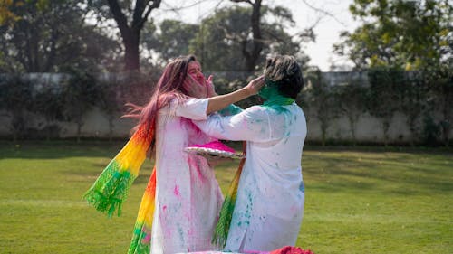 A Man and Woman Touching Faces while Playing at the Field