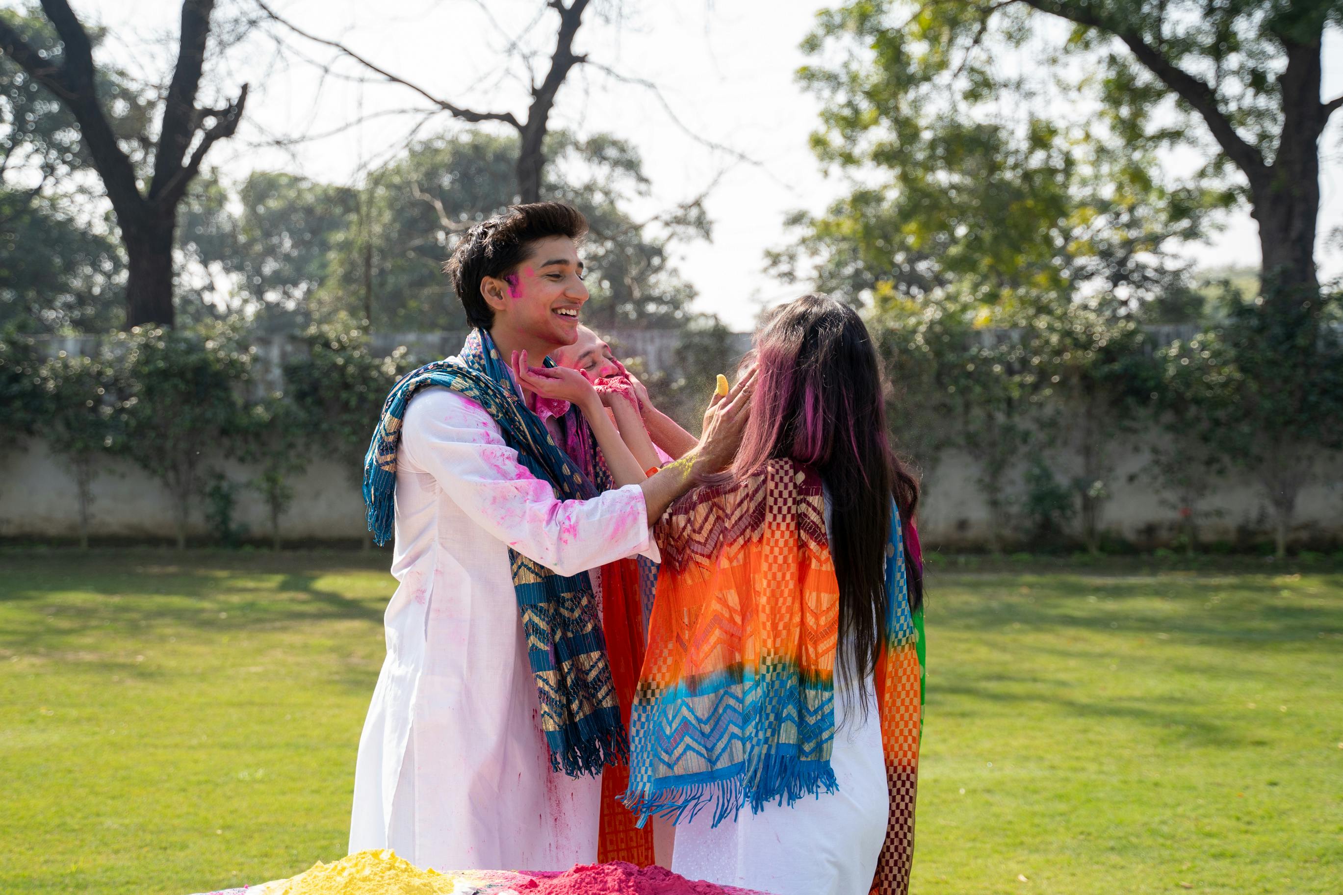 Premium Photo | Indian people celebrating holi with sweet laddu, colours in  thali and colour splash