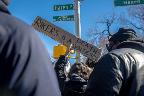Free Protest at New York intersection with sign 'Rikers is a death sentence'. Stock Photo