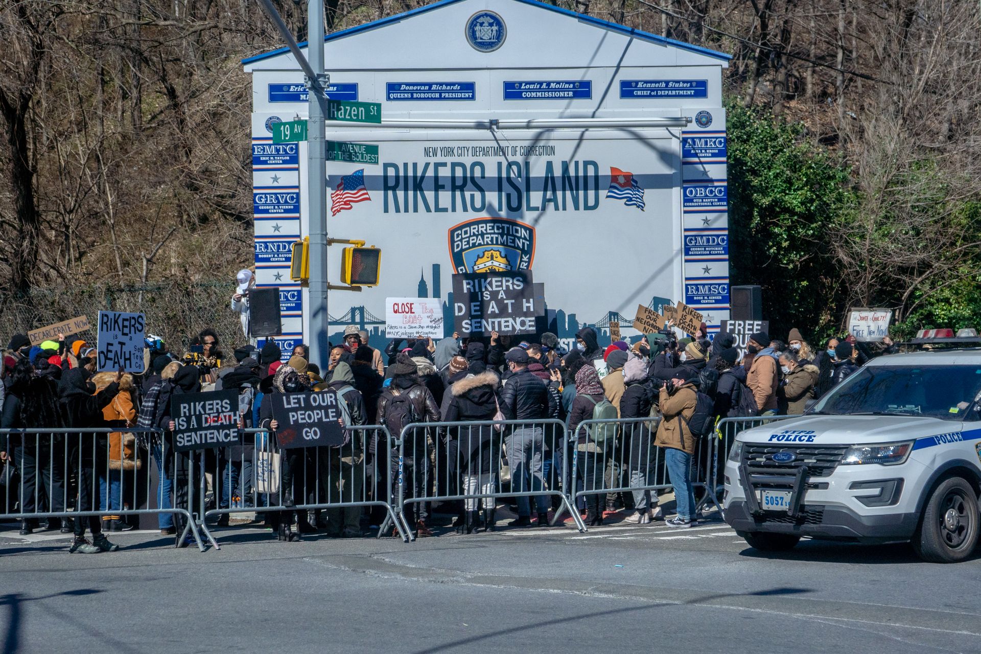 Protestors gather outside Rikers Island in New York City, advocating for prison reform.