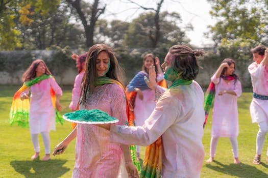Group of young adults celebrating Holi with vibrant colors outdoors.