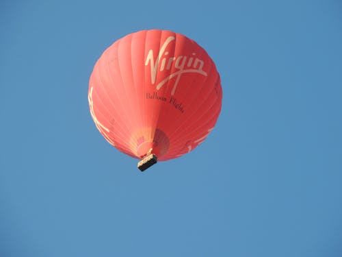 Low Angle Shot of Red Hot Air Balloon Under Blue Sky