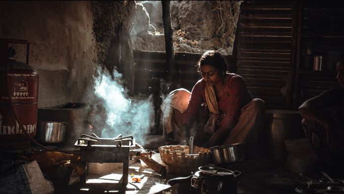 Real photo of traditional rural Indian cooking near a spice farm