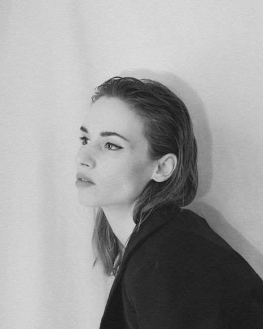 Grayscale portrait of a woman looking into the distance, adding depth and emotion.