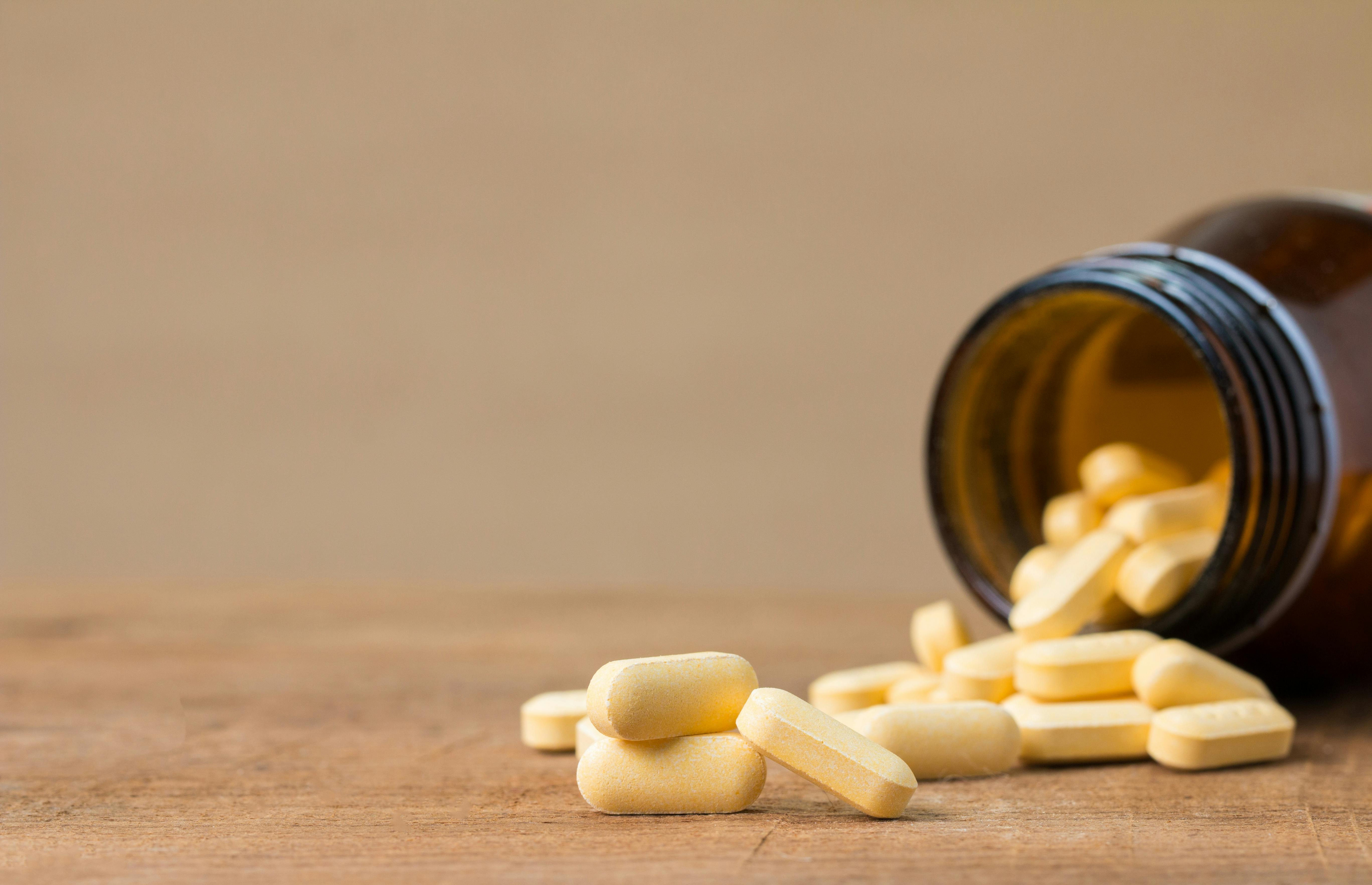 yellow medicinal tablets from a container