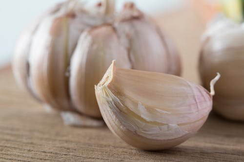 Clove of Garlic on Wooden Surface