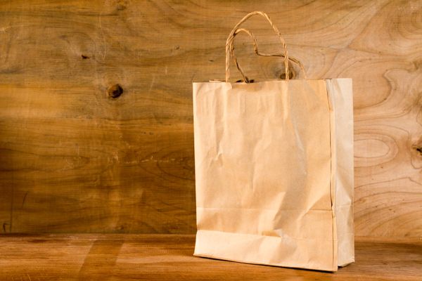 Kraft paper bags and food packaging on a light background