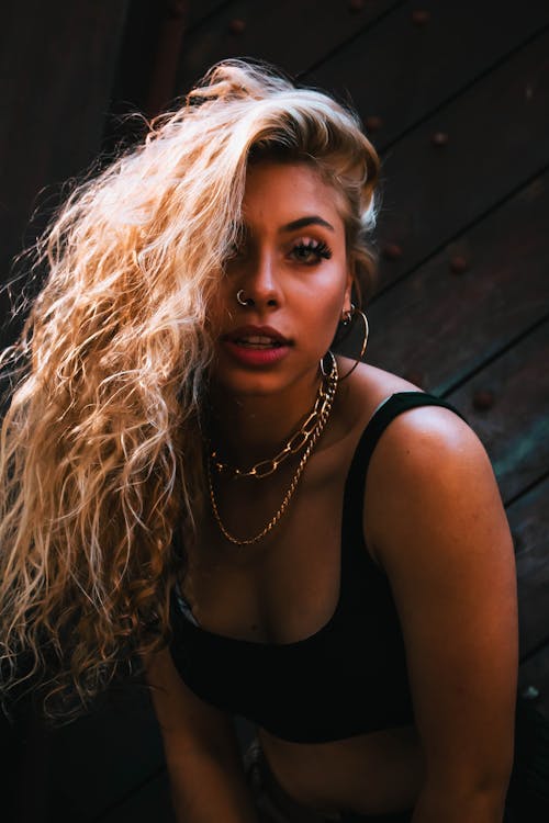 A Woman in Black Tank Top With Chain Necklace