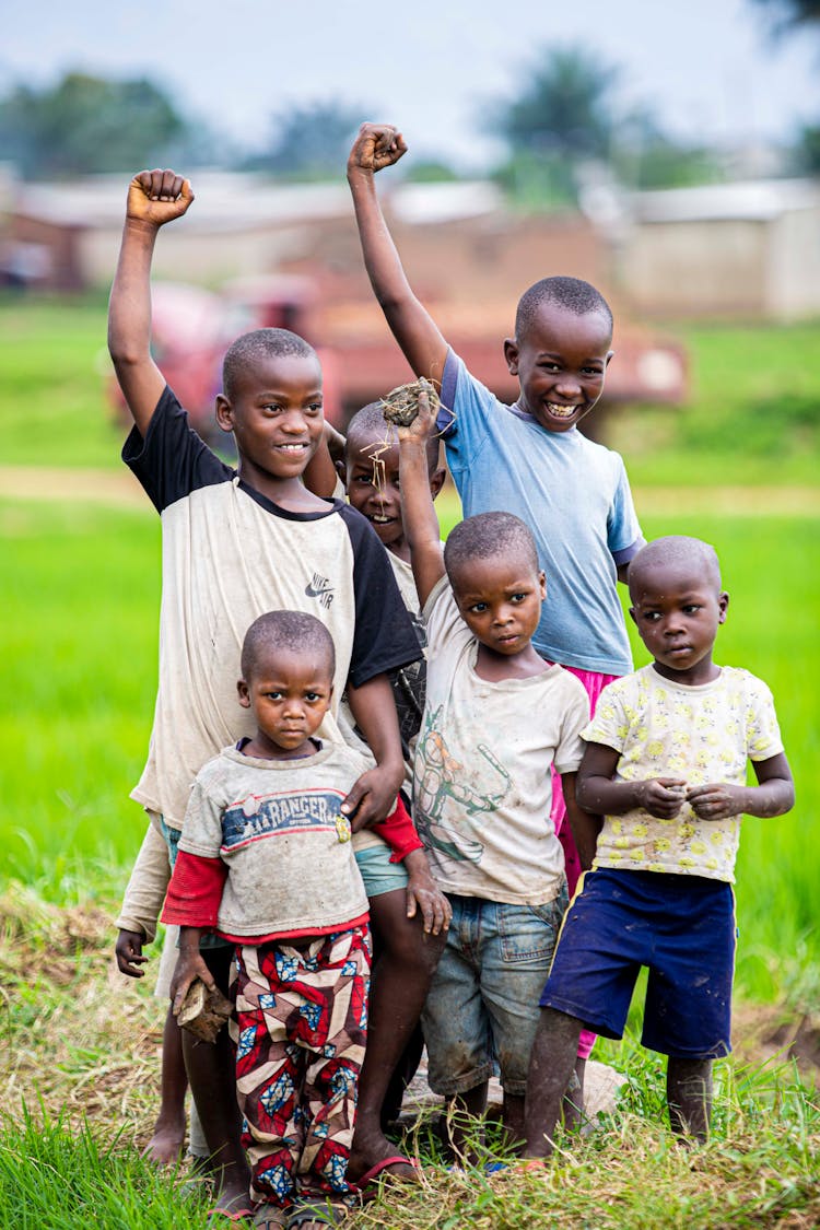 Children Standing On Withered Grass 