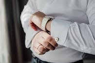 Unrecognizable Man Fastening Cuff Link of White Shirt