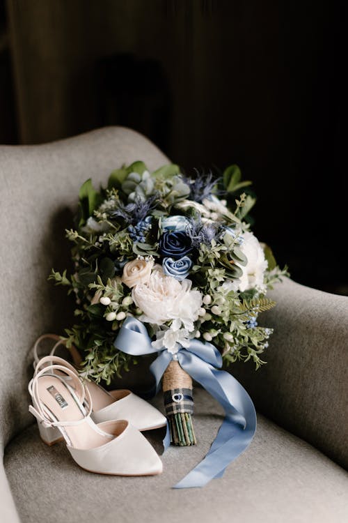 White and Blue Bouquet of Flowers on Gray Sofa