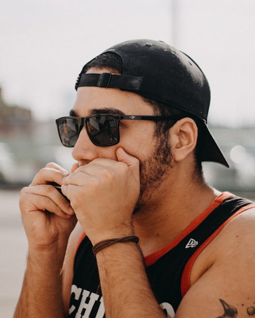 Man in yellow and red tank top wearing black sunglasses photo – Free Miami  Image on Unsplash