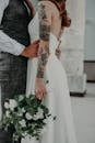 Unrecognizable Groom Holding Bride at Waist
