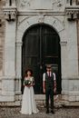 Bride and Groom Posing in Front of Cathedral Gate