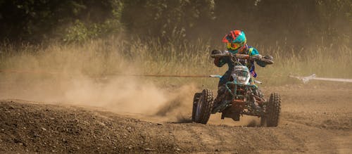 Man Riding Atv on Race Track