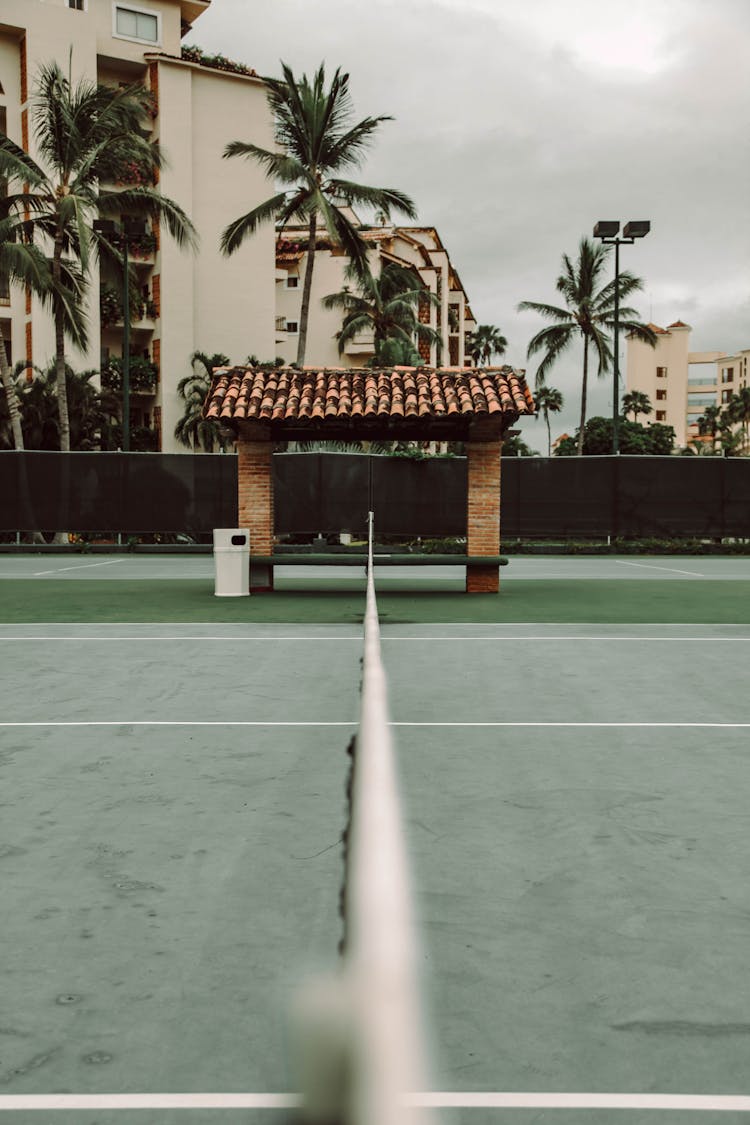 Empty Tennis Court With A Shed