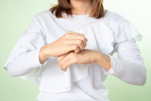 Hands on Person Wearing White Blouse