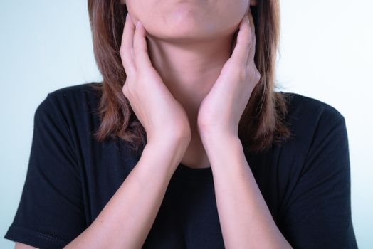 Close-up of Woman Touching Her Tonsils 