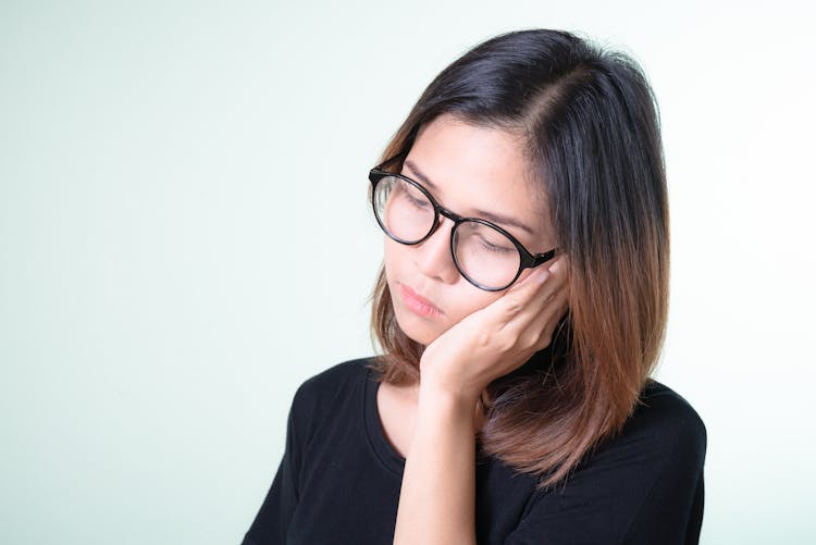 Woman Putting Her Hand To Her Cheek 