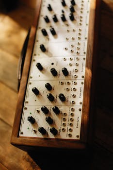 Close-up of a vintage music mixer showcasing analog knobs and wood finish.