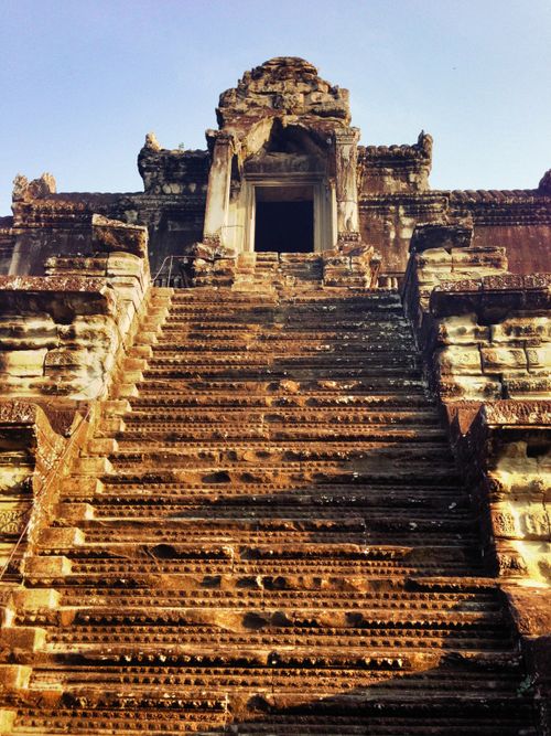 Free Low angle view of ancient stone stairs leading to the Angkor Wat temple entrance in Cambodia. Stock Photo