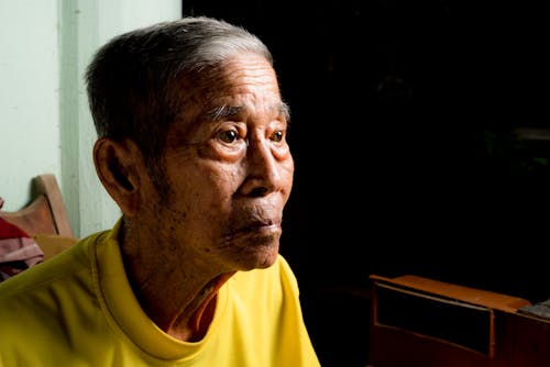 Elderly Man Sitting Inside 